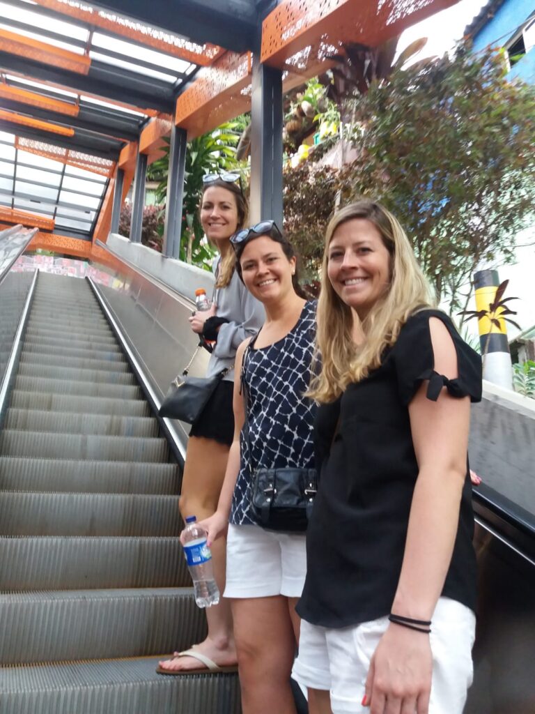 Visitors riding the outdoor escalators in Comuna 13, Medellín